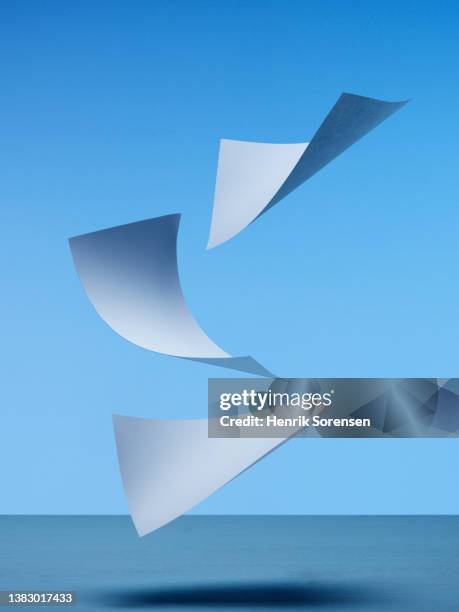 white paper flying - paper flying stock pictures, royalty-free photos & images