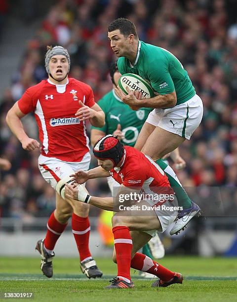 Rob Kearney of Ireland catches the high ball despite the challenge from Leigh Halfpenny during the RBS Six Nations match between Ireland and Wales at...