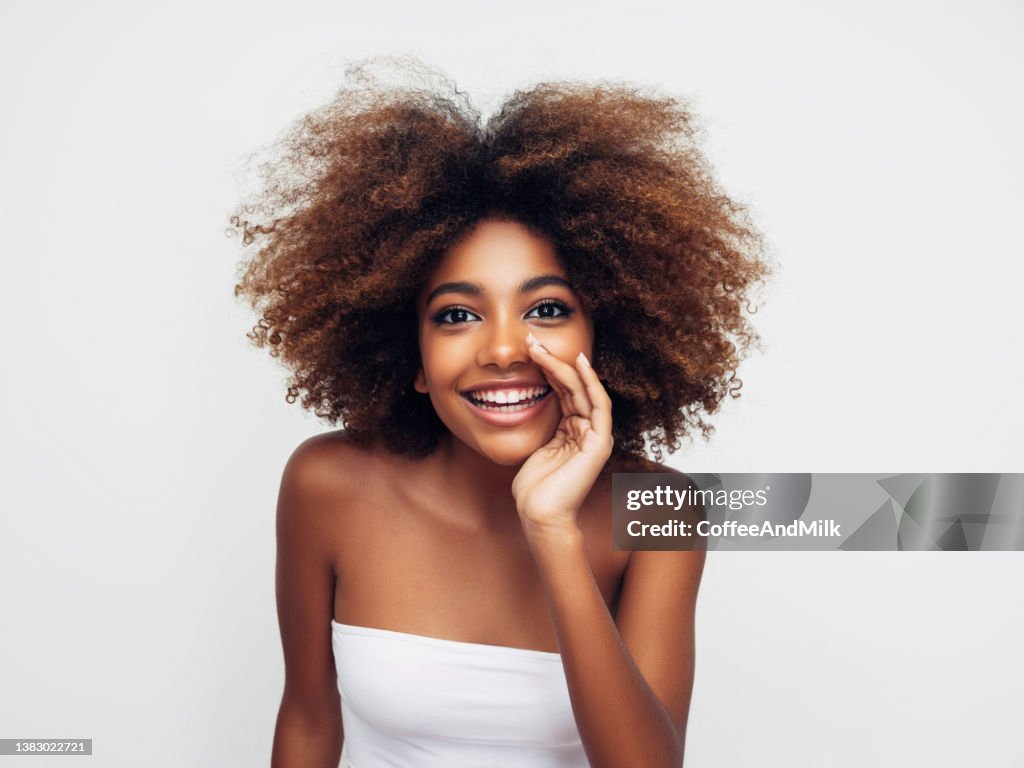 Beautiful smiling girl with curly hairstyle