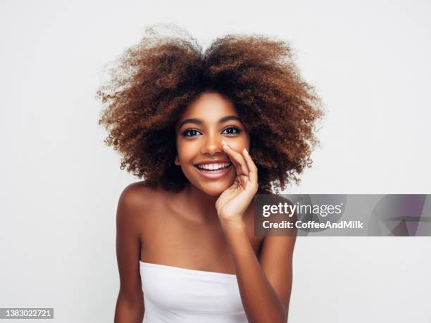 beautiful smiling girl with curly hairstyle - natural black hair stock pictures, royalty-free photos & images