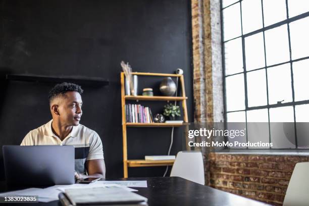 young professional man working in modern office space - office desk top view stockfoto's en -beelden