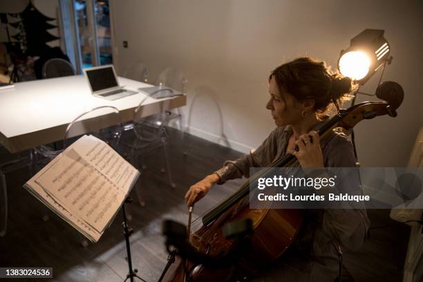 woman plays the cello at home - cello stock pictures, royalty-free photos & images