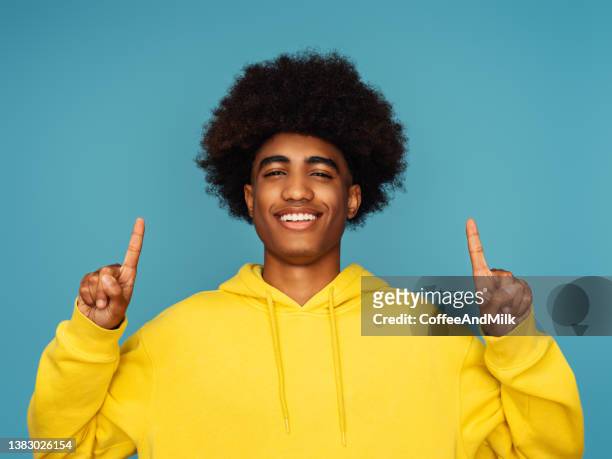 african american man with afro hair standing over isolated  background - man and his hoodie imagens e fotografias de stock