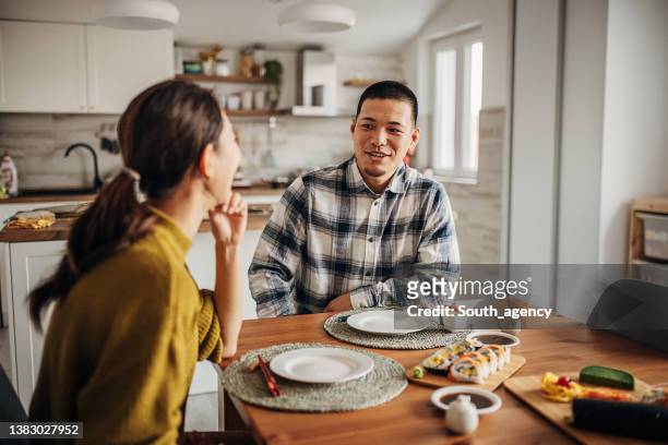 couple having sushi at home - the japanese wife stock pictures, royalty-free photos & images