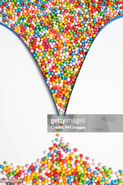 funneling multi colored balls - perlenschmuck stock-fotos und bilder