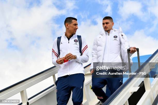 Angel Di Maria and Marco Verratti walk out of the plane as the Paris Saint-Germain team arrive in Madrid before the UEFA Champions League Round Of...