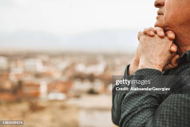 praying hands wrapped together of senior adult thinking with hope about better future - god is love stock pictures, royalty-free photos & images