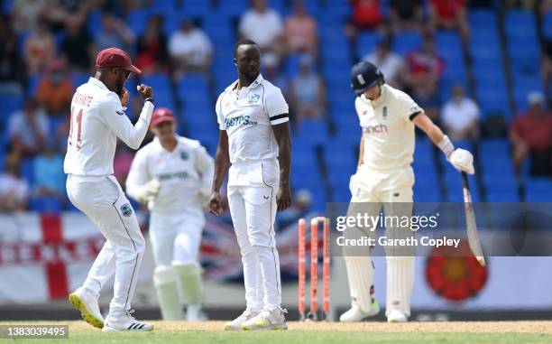 Kemar Roach of the West Indies celebrates dismissing England captain Joe Root during day one of the first test match between West Indies and England...