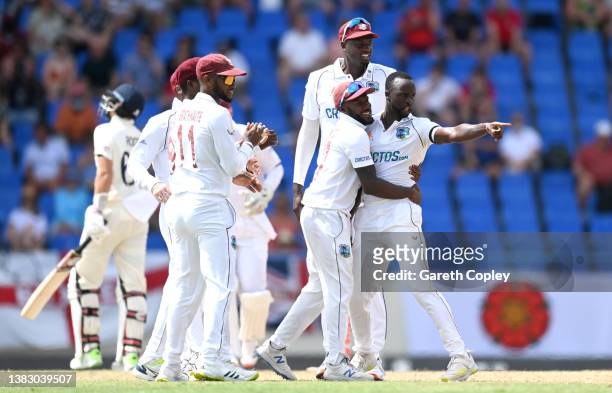 Kemar Roach of the West Indies celebrates dismissing England captain Joe Root during day one of the first test match between West Indies and England...