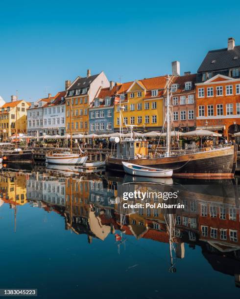 copenhagen iconic view. famous old nyhavn port in the center of copenhagen, denmark during winter sunny day - copenhagen street stock pictures, royalty-free photos & images