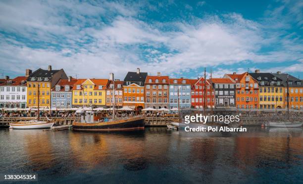 copenhagen iconic view. famous old nyhavn port in the center of copenhagen, denmark during winter sunny day - copenhagen stock pictures, royalty-free photos & images