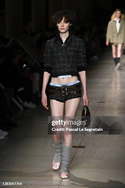 Model walks the runway during the Miu Miu Womenswear Fall/Winter 2022-2023 show as part of Paris Fashion Week on March 08, 2022 in Paris, France.