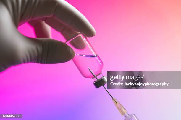 syringe inserted into a vaccine vial - immunotherapy stock pictures, royalty-free photos & images