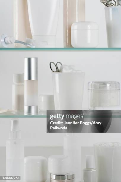 medicine cabinet full of skincare products - badezimmerschrank stock-fotos und bilder