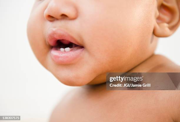 close up of black baby's mouth - baby tooth stock-fotos und bilder