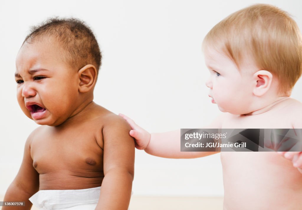 Baby consoling crying friend