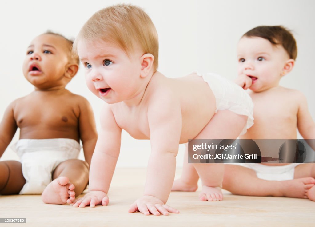 Babies playing together on floor