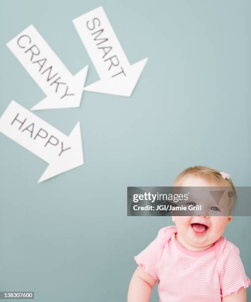 caucasian baby near arrows reading cranky, smart and happy - pre labeled stockfoto's en -beelden