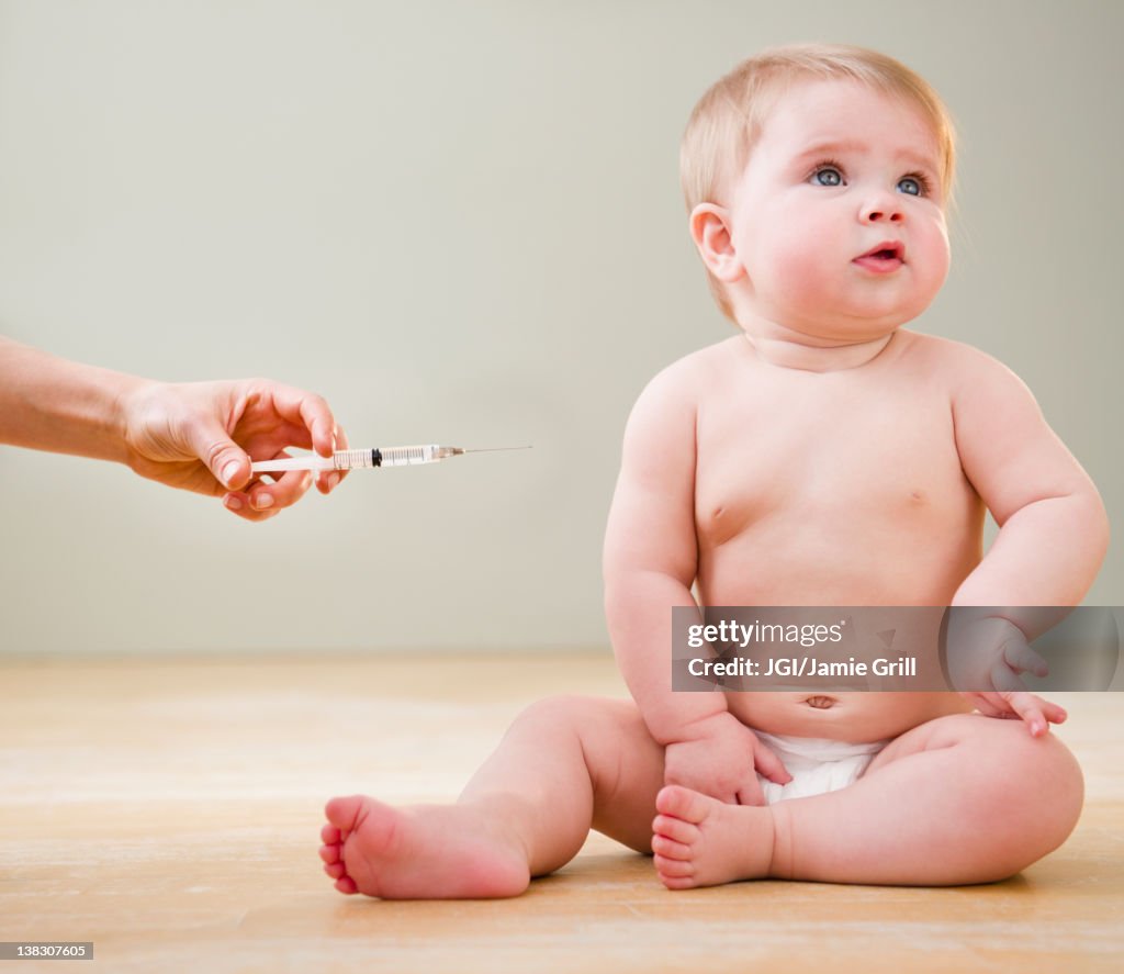 Doctor giving Caucasian baby injection