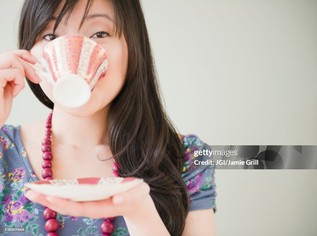 Elegant Korean woman drinking coffee