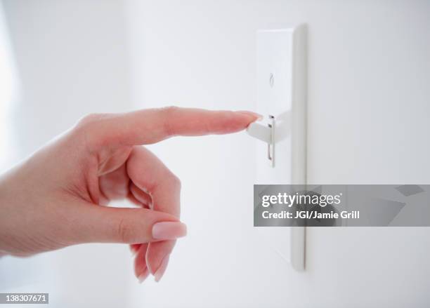 korean woman turning off light switch - turning on or off imagens e fotografias de stock