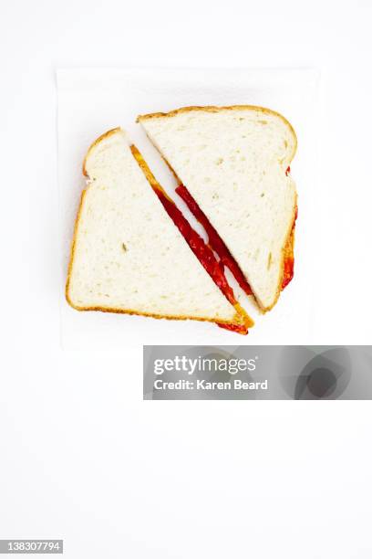 one peanut butter and jelly sandwich cut in half - cut in half ストックフォトと画像