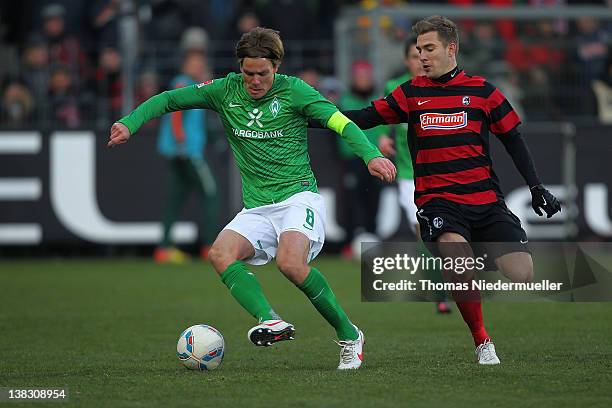 Erik Jendrisek of Freiburg fights for the ball with Clemens Fritz of Bremen during the Bundesliga match between SC Freiburg and Werder Bremen at Mage...