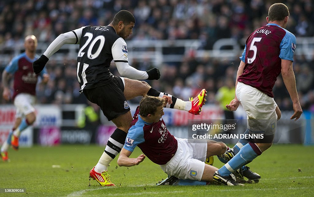 Aston Villa's Stephen Warnock (C) blocks