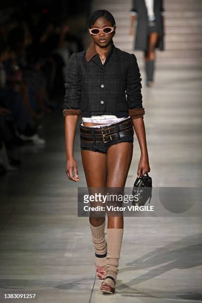 Model walks the runway during the Miu Miu Ready to Wear Fall/Winter 2022-2023 fashion show as part of the Paris Fashion Week on March 8, 2022 in...