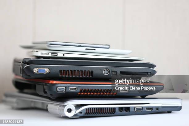 stack of laptops ready for recycling - damaged laptop stock pictures, royalty-free photos & images