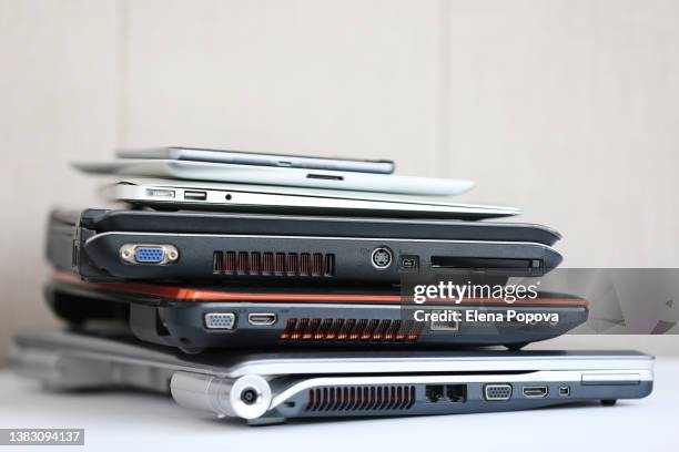 stack of laptops ready for recycling - technology stack stock pictures, royalty-free photos & images