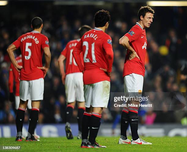 Despair for Jonny Evans , Rafael da Silva and Rio Ferdinand of Manchester United as David Luiz scores Chelsea's third goal during the Barclays...