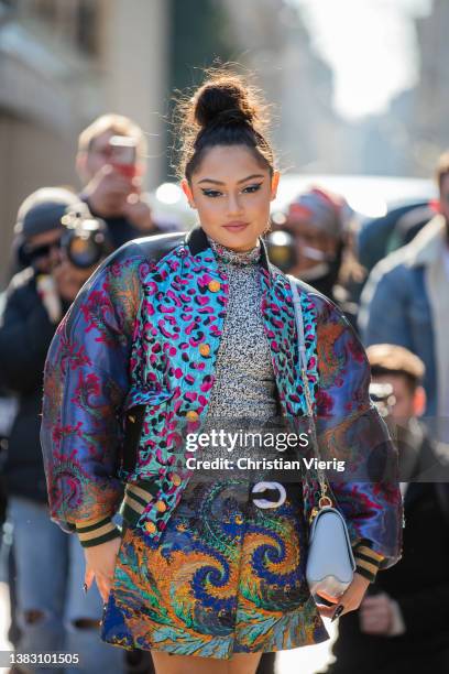 Avani Gregg is seen wearing grey bag, mixed pattern jacket with animal print, skirt with print, silver top outside Louis Vuitton during Paris Fashion...