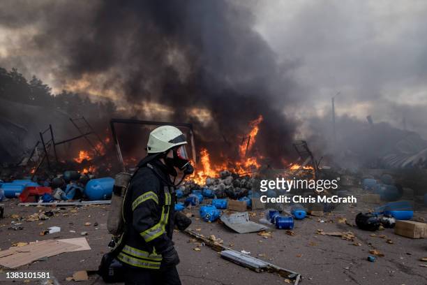 Firefighters try to extinguish a fire after a chemical warehouse was hit by Russian shelling on the eastern frontline near Kalynivka village on March...