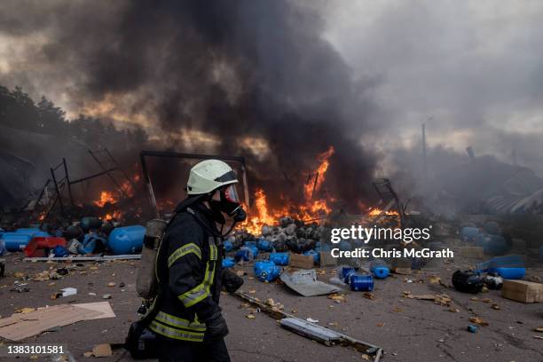 Firefighters try to extinguish a fire after a chemical warehouse was hit by Russian shelling on the eastern frontline near Kalynivka village on March...