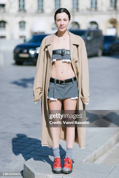 Simona Carlucci poses wearing a Miu Miu camel coat, Miu Miu top crop and mini skirt and Miu Miu spikes shoes after the Miu Miu show at the Palais de...