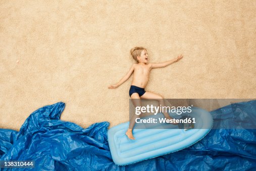 Boy Inflatable Raft Germany Boy On Inflatable Raft In Water At Beach High-Res Stock Photo ...