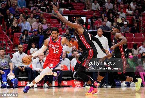 Tobias Harris of the Philadelphia 76ers drives to the basket against Bam Adebayo of the Miami Heat in the first half at FTX Arena on March 05, 2022...