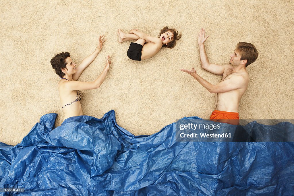 Germany, Artificial beach scene with family having fun in waves