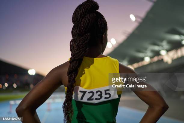 female track and field athlete with long black braids in stadium - cape town night stock pictures, royalty-free photos & images