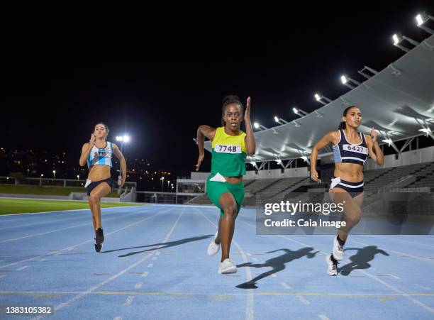 female track and field athletes running in competition on track - track and field event stock pictures, royalty-free photos & images