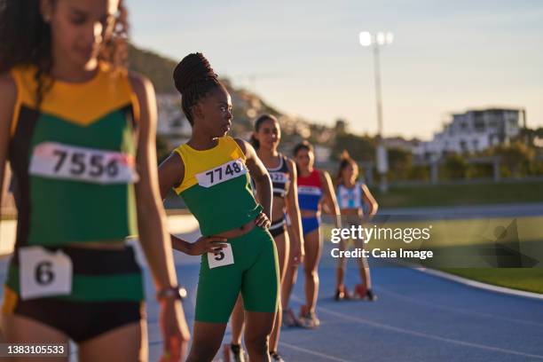 female track and field athletes preparing at starting blocks on track - track and field event stock pictures, royalty-free photos & images