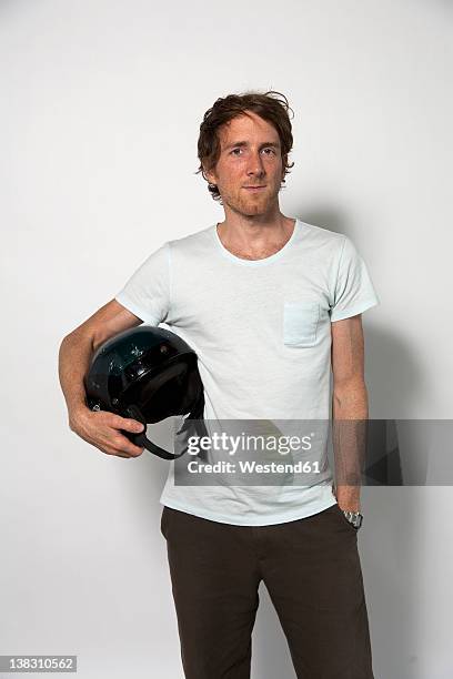 man carrying helmet against white background - under the arm stock pictures, royalty-free photos & images