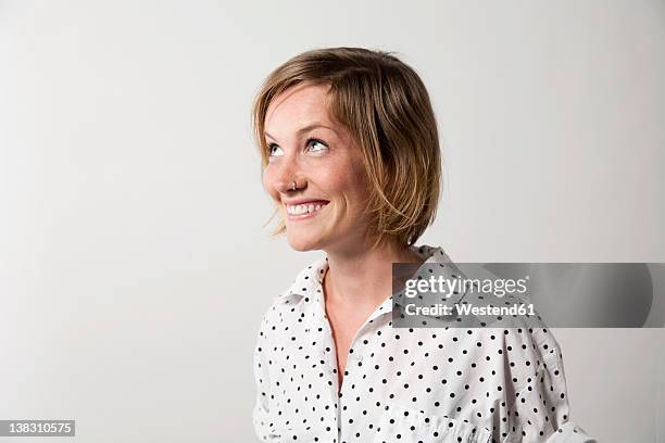 woman with facial expression against white background - woman looking up stock-fotos und bilder