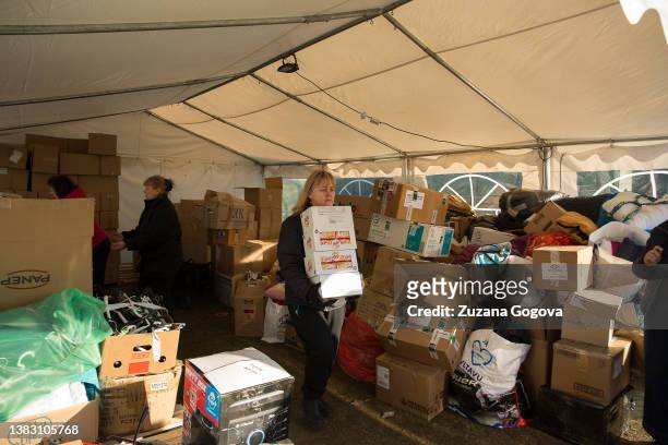 Women help to load the van with the donated food that will be driven to Ukraine on March 6, 2022 in Vysne Nemecke, Slovakia. Women are helping at the...