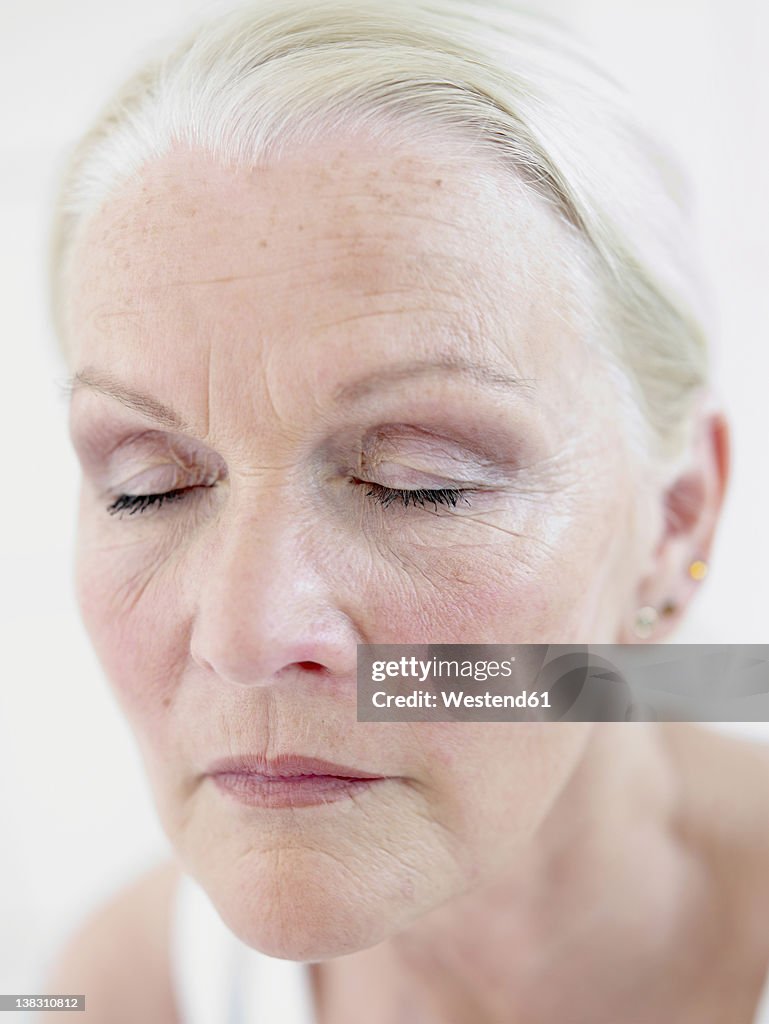 Senior woman with eyes closed, close up