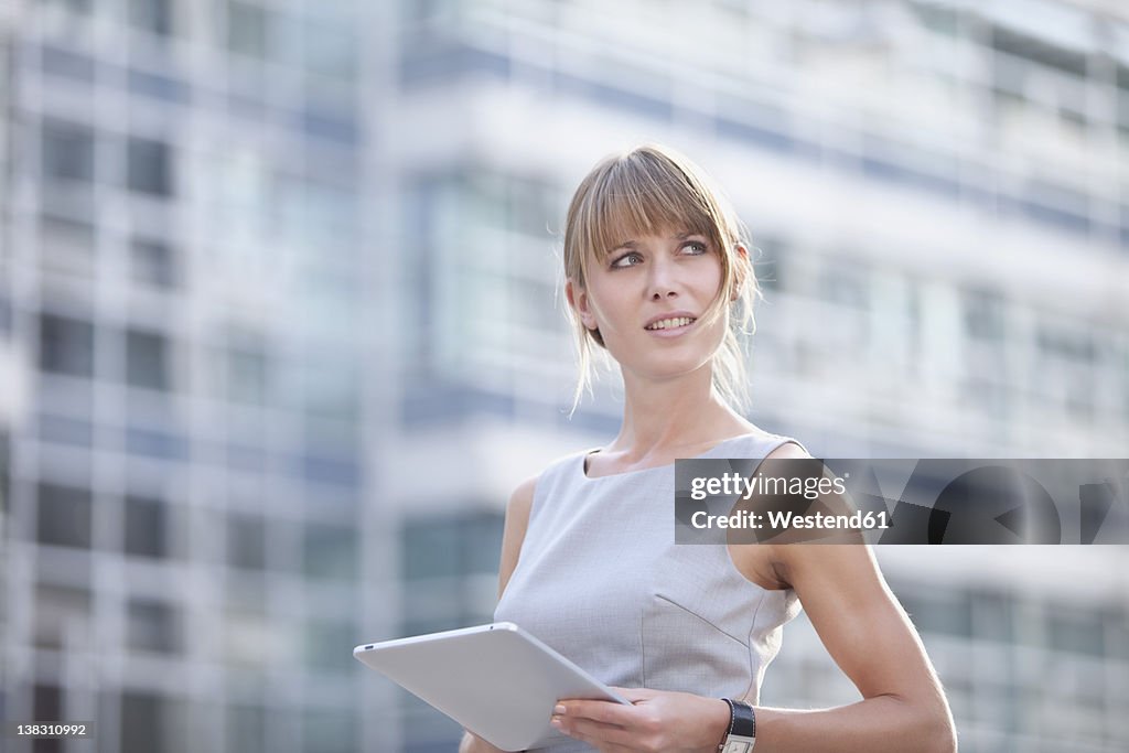 Germany, Bavaria, Munich, Young businesswoman with digital tablet