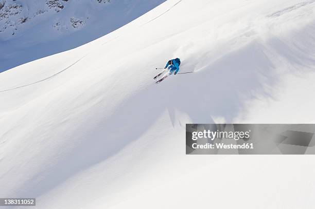austria, zurs, lech, young man doing alpine skiing on arlberg mountain - lech stock pictures, royalty-free photos & images