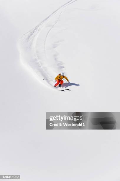 austria, young woman doing alpine skiing - alpine skiing stock pictures, royalty-free photos & images