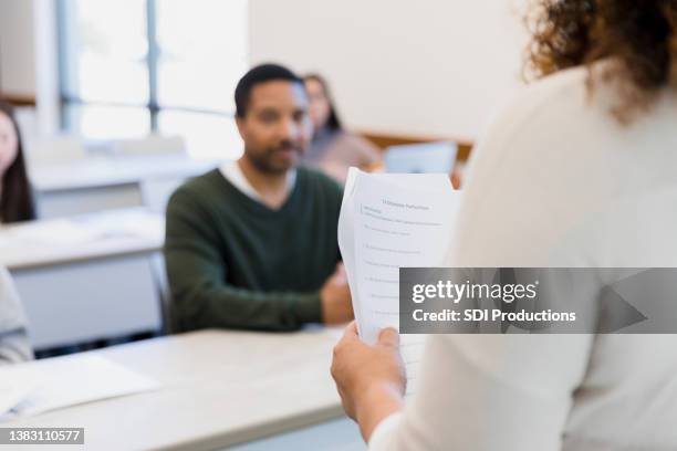 proctor administering exam - examinator stockfoto's en -beelden